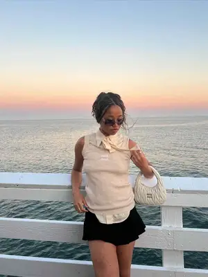 Salem Mitchell wearing a tan tank top, black mini skirt, and sunglasses