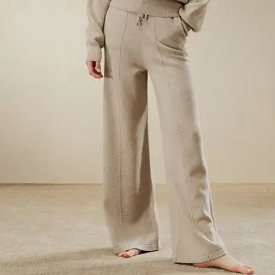 A gold necklace with a tiger eye pendent 