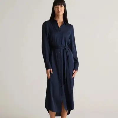 A model wearing a navy blue silk maxi shirtdress 