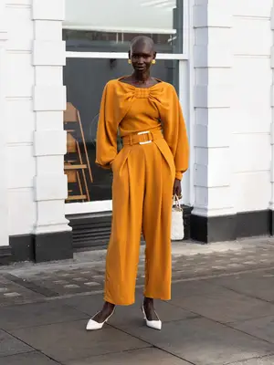 Model wearing a dark red oversized v-neck sweater