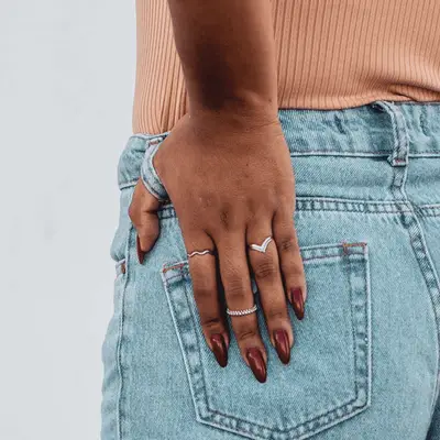 Black woman wearing white top and blue jeans