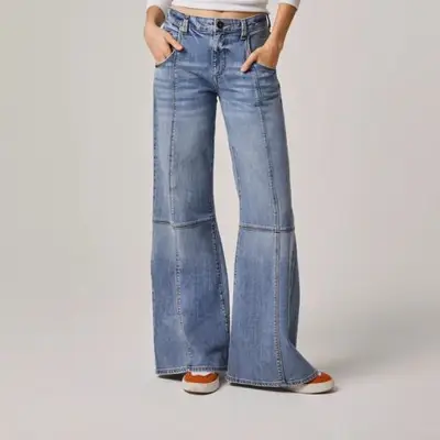 Edyson Cary High Rise Wide Leg Jeans on model styled with red and white sneakers