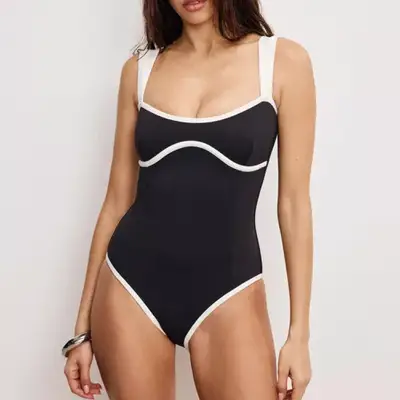 model wearing a black and white contrast piping Good American swimsuit