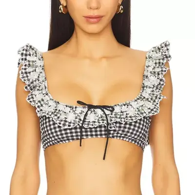 model with a black and white gingham and ruffle bikini top