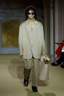 Model at the Coach S/S24 show holding a giant bag