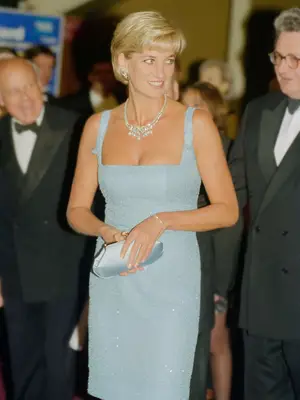 Princess Diana wearing blue Jacques Azagury dress and diamond necklace, holding blue satin clutch