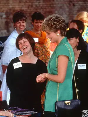 Princess Diana wearing green top and holding black Ferragamo bag with gold chain