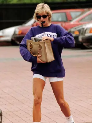 Princess Diana wearing purple crewneck, white biker shorts, and rummaging through her Gucci bag