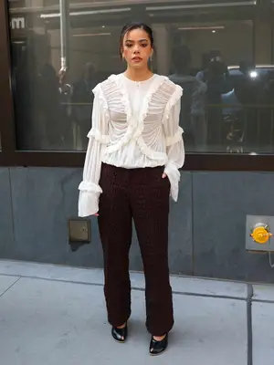 Antonia Gentry wears a ruffled top and brown ruched trousers