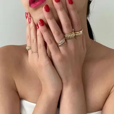 A woman wears gold-plated jewelry