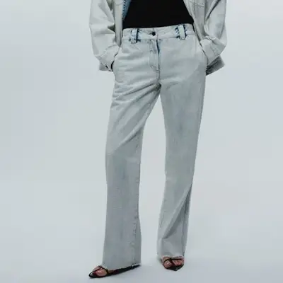 Saint Art Nessa Bleached Embellished Denim Pant in light wash denim on model styled with matching jacket and black top and shoes