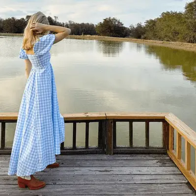 Woman wearing red dress and black boots
