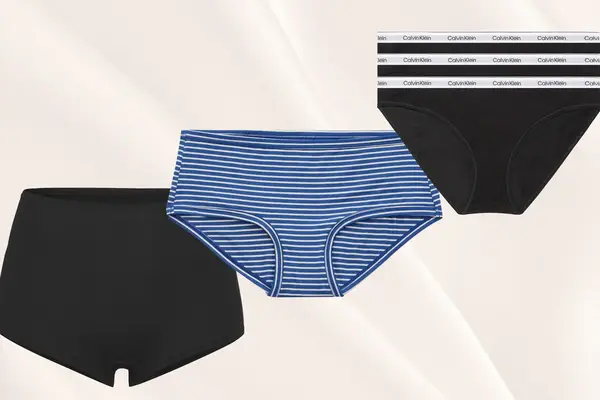 Three pairs of cotton underwear on cream background