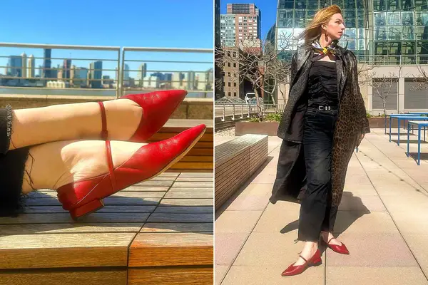 A close up of a person wearing a pair of red M Gemi The Loriana flats next to a person wearing a pair of red M Gemi The Loriana flats