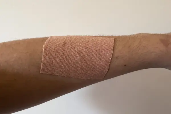 A piece of Nue Breast Tape is applied to a person