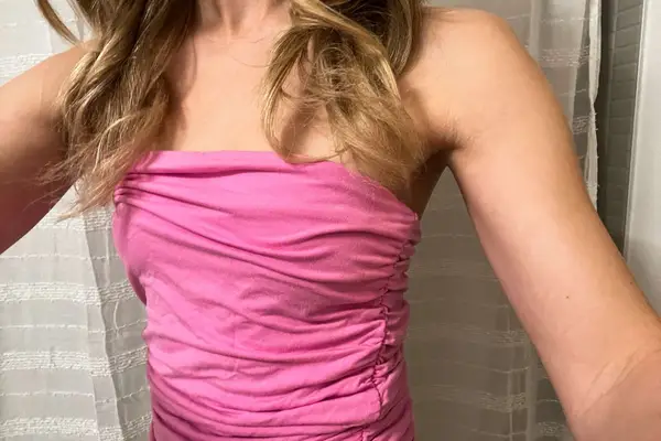 A person wears Kmboobies Boob Tape under their shirt