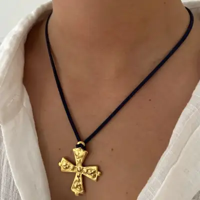 black cord necklace with gold cross