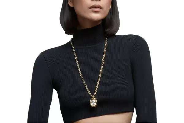 A person wearing a Swarovski pendant