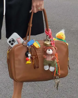 A Miu Miu bag decorated with charms.