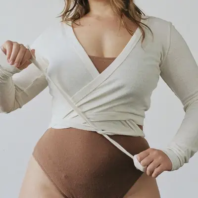 Ozma Dance Wrap Top in natural silk noil jersey on model styled with brown leotard