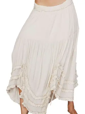 person wearing a ruffled white Free People midi skirt