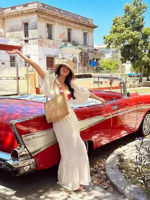 Person wearing a textured buttoned sweater and trousers, focus on clothing