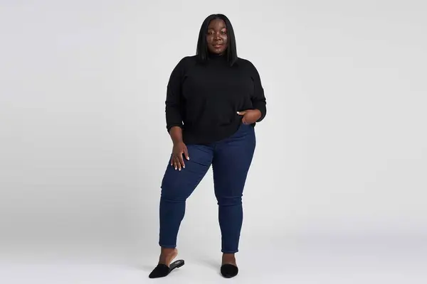 Woman wearing black sweater and jeans