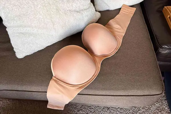 Spanx Up For Anything Strapless Bra displayed on a sofa 