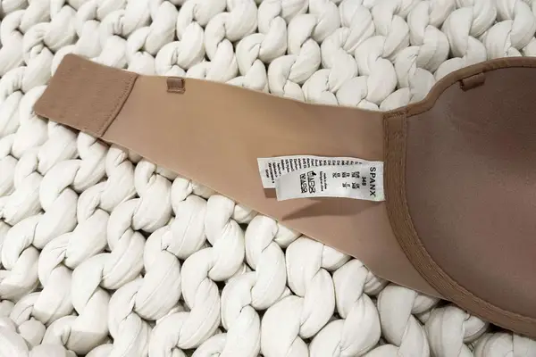 Closeup of a tag on the Spanx Up For Anything Strapless Bra