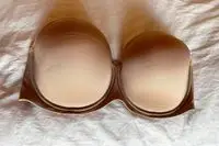 Spanx Up For Anything Strapless Bra displayed on a white sheet