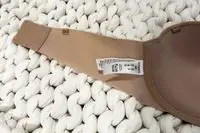 Closeup of a tag on the Spanx Up For Anything Strapless Bra