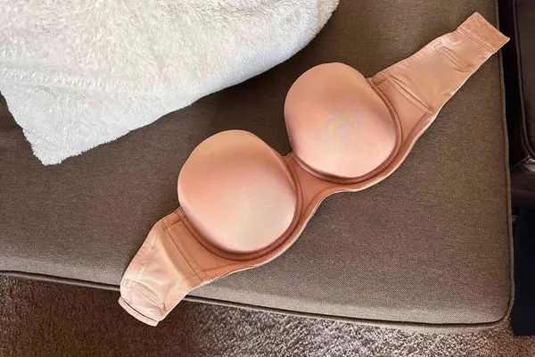 Wacoal Red Carpet Strapless Underwire Bra displayed on a couch