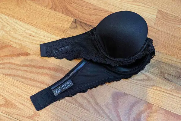 Natori Feathers Strapless Bra displayed on a wooden floor 