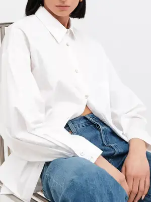 Sofia Richie Grainge wears a gray pinstriped boatneck top and trousers