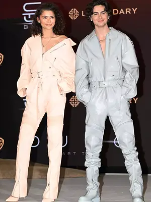 Zendaya and Timothee Chalamet wear pastel pink and blue leather jumpsuits by Juun J to the Dune Part Two press conference in Korea