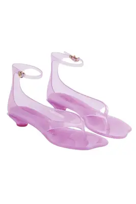 A pair of pink Chloe jelly sandals set against a white background.