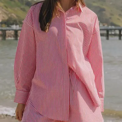 Daily Drills Poplin Button Down in red and white stripe on model styled with matching shorts