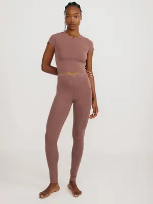 Model wearing baby tee and leggings