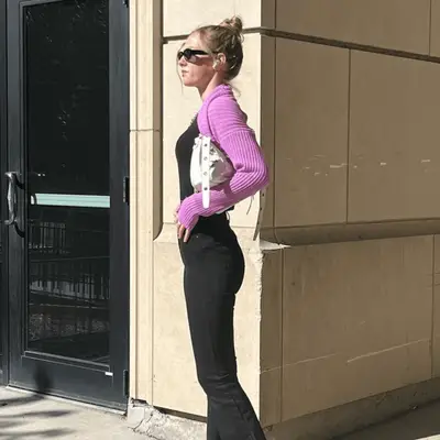 woman in all black with purple bolero