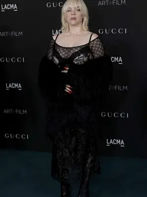 Billie Eilish wears a black Gucci dress with sheer top and lacy bra to the 2021 LACMA Art + Film Gala