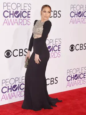 Jennifer Lopez wears a black form-fitting Reem Acra gown with silver chest embroidery to the 2017 People