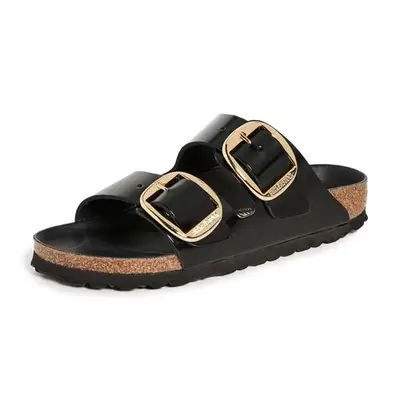 Black Birkenstock sandals with gold buckles