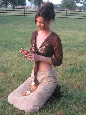 Bella Hadid wears a brown top, cargo skirt, and boots