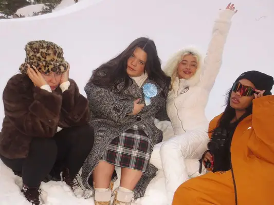 Sabrina Carpenter and friends wear snow gear, outerwear, and winter accessories
