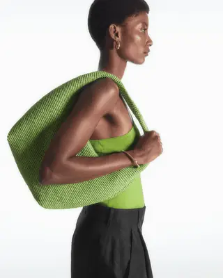 Model carrying a bright green bag