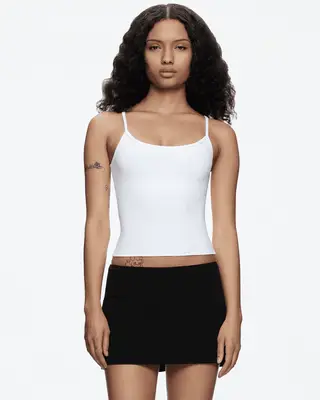 model wearing a white tank top
