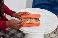 A person closes the Calpak Jewelry Case
