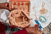 A person opens the Calpak Jewelry Case