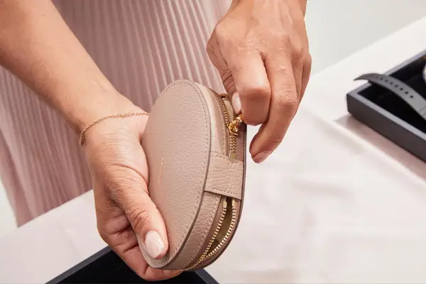 Hands holding a Cuyana Travel Jewelry Case