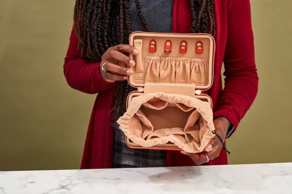 A person shows in the interior of the Calpak Jewelry Case